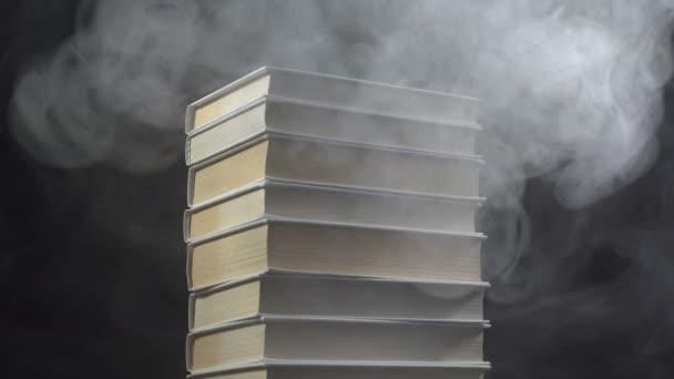 Books and white smoke on black background — Stock Video