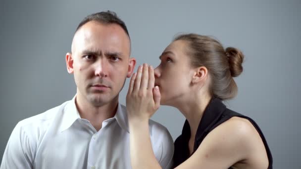 Video of girl talking secret on grey background — Stock Video