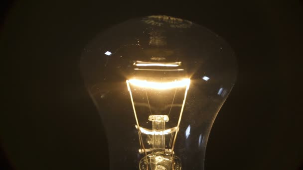 Filament lamp on black background — Stock Video