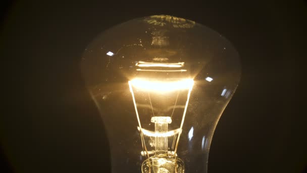 Video of incandescent bulb on black background — Stock Video