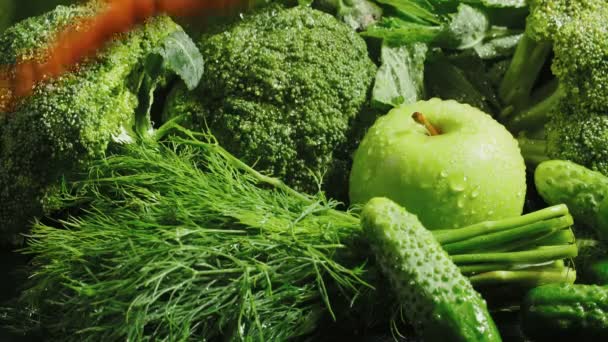 Video of green vegetables with falling carrot — Stock Video