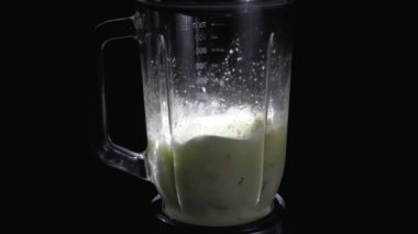 Siyah bir arka plan üzerinde bir blender diyet sebze sallayarak