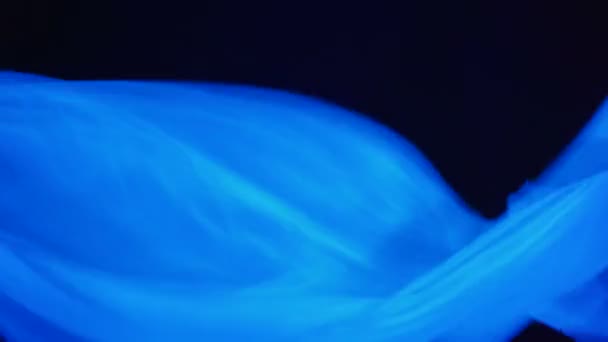 Video of white waving fabric in ultraviolet light — Stock Video