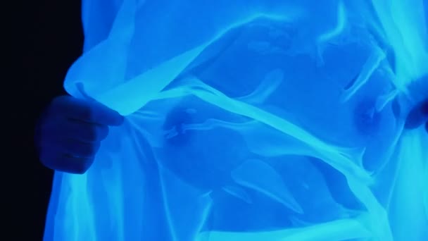 Girl with naked breast and wet fabric in ultraviolet light — Stock Video