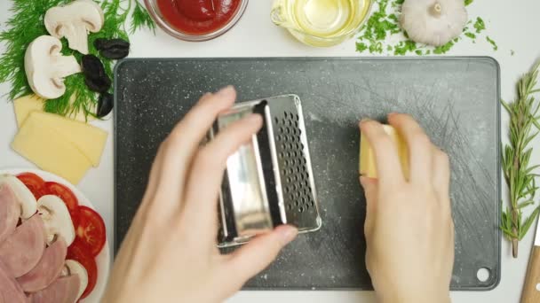 Schieten van geraspte kaas in de keuken — Stockvideo