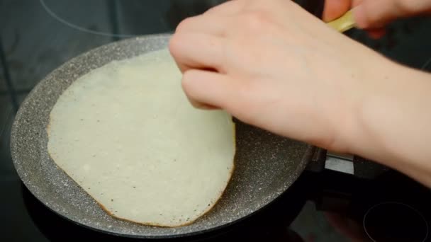 Video of dough for thin crepes in the skillet — Stock Video