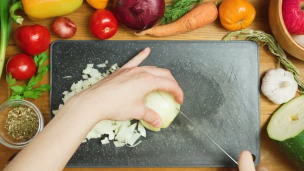 Video einer jungen Frau schneidet Zwiebel, Ansicht von oben — Stockvideo