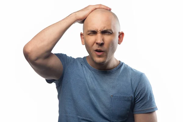 Photo of young shaved man touching his head on white background — ストック写真