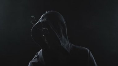 Gölgede e-sigarası olan adam.