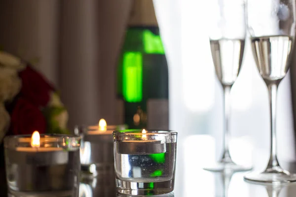 Bild av champagne med ljus på nattduksbordet — Stockfoto