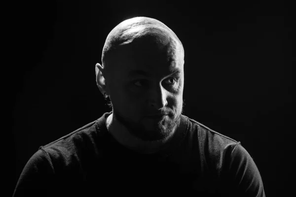 Black and white portrait of bald man on black background — Stock Photo, Image
