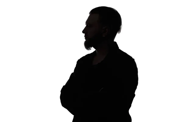 Silhouet van een man met baard met gekruiste armen — Stockfoto