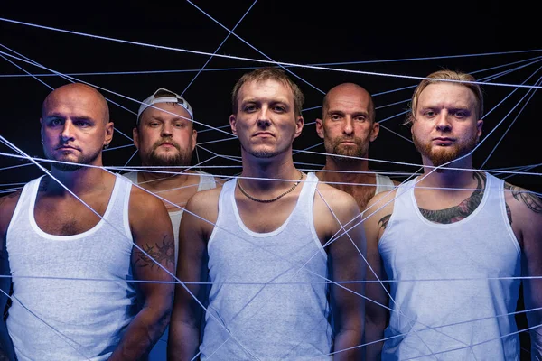 Photo of group of men tangled in white threads in ultraviolet — Stock Photo, Image