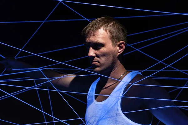 Picture of man tangled in white rope in neon light — Stock Photo, Image