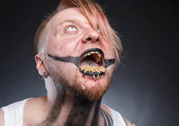 Portrait of a scary mad man with maggots in his mouth — Stock Photo, Image