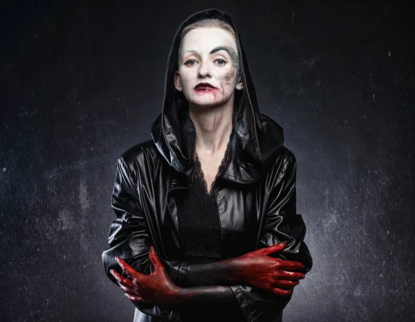 Photo of woman in black leather raincoat with red hands — Stock Photo, Image