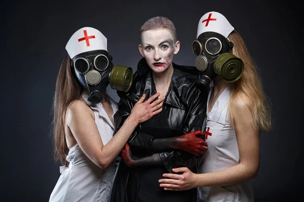 Portrait of three women in role play - nurses and evil one — Stock Photo, Image