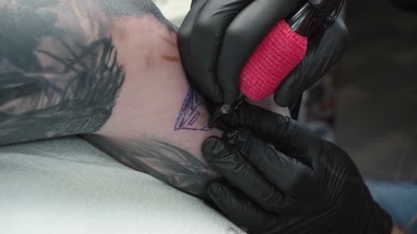 Видео, как человек делает татуировку на локте в салоне — стоковое видео