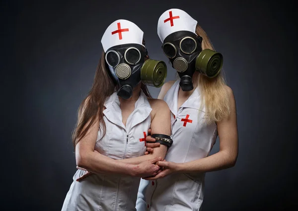 Image of slim young fake nurses in gas mask — Stock Photo, Image