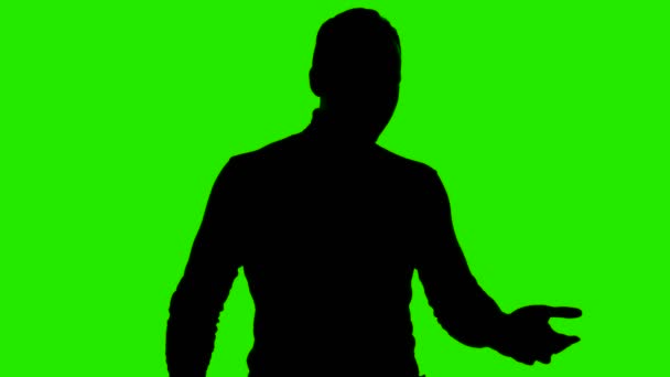 Video of mans silhouette showing facepalm gesture on isolated green background — Stock Video