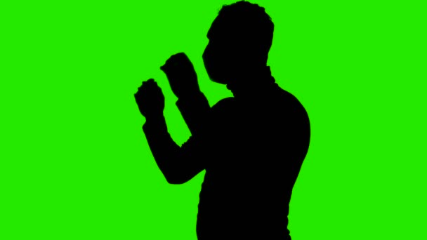 Video van mannen silhouet uitkleden medisch masker op groene achtergrond — Stockvideo