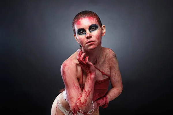 Młoda kobieta w sztucznej krwi na szarym tle — Zdjęcie stockowe