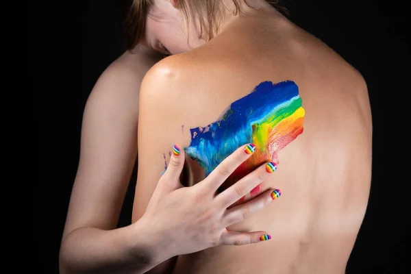 Immagine di donna che dipinge arcobaleno sulla schiena nuda — Foto Stock