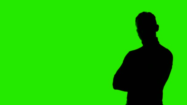 Video of mans silhouette with arms crossed and copyspace on green background — Stock Video