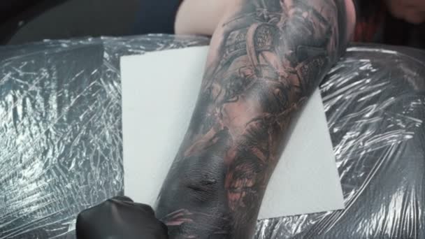 Nagranie tatuażysty robiącego tatuaż na łokciu w salonie — Wideo stockowe
