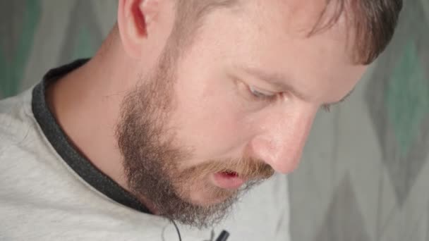 집에서 수염을 기른 젊은 남자에게 말하는 행동 — 비디오