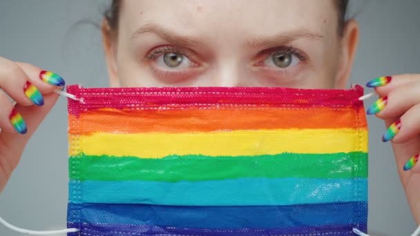 Footage of woman looking at rainbow protective mask — Stok Video