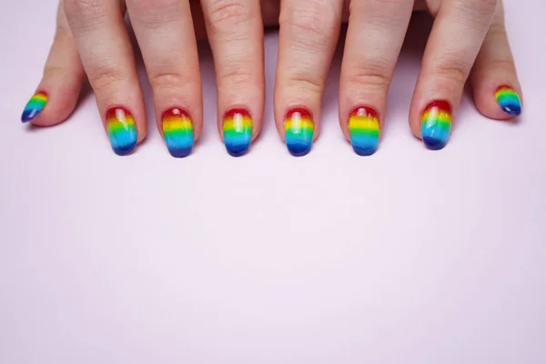 Bild von weiblichen Händen mit Regenbogennägeln an der Spitze — Stockfoto