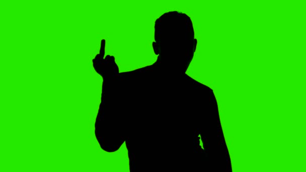 Video mans silueta ukazující fuckfinger na zeleném pozadí — Stock video