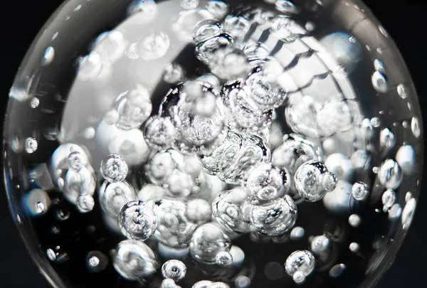 Image of bubbles in glass transparent sphere on black background — Stock Photo, Image