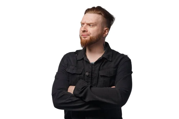 Photo of puzzled bearded man in black jeans jacket — Stock Photo, Image