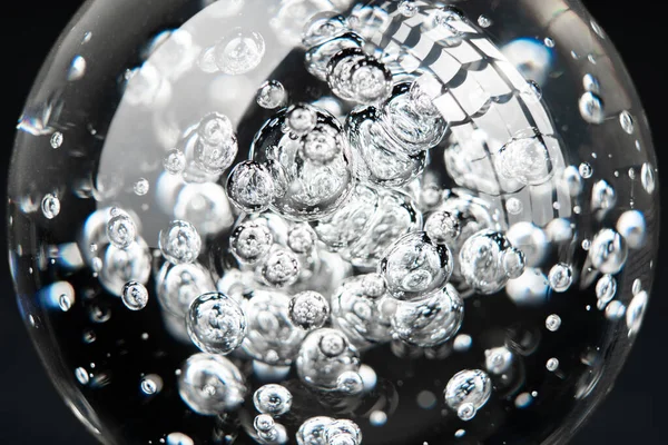 Bubbles in glass sphere on black background — Stock Photo, Image