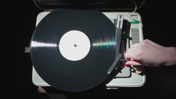 Vidéo de fille avec des ongles rouges éteignant vieux gramophone — Video