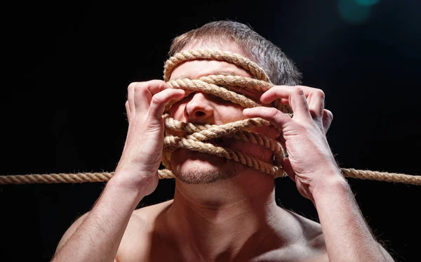 Photo of binded man with rope and hands on face — Stock Photo, Image