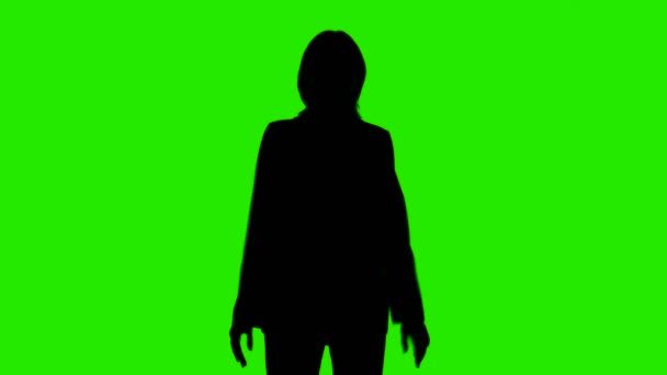 Videó a nők sziluett öltöny kabát zöld háttér — Stock videók