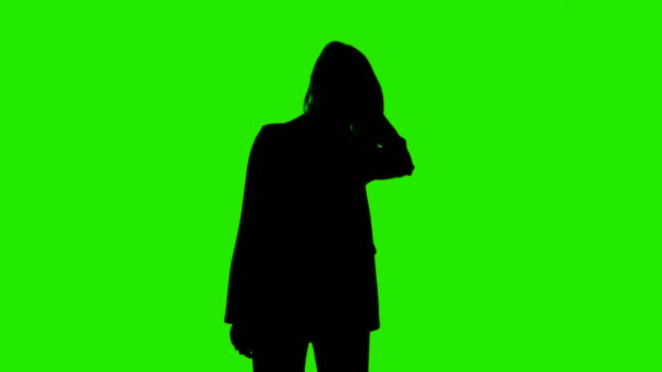 Video of womans shaking head silhouette in suit jacket on green background — Stock Video