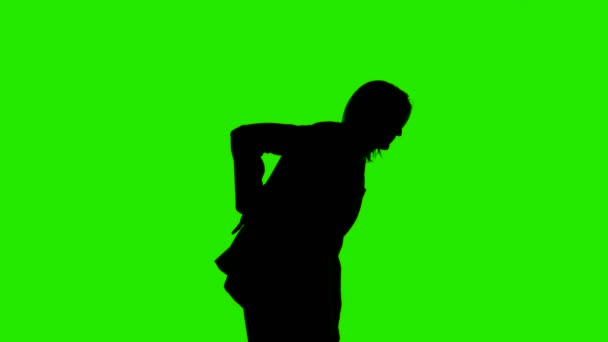 Video of womans silhouette in suit jacket with backache on green background — Stock Video