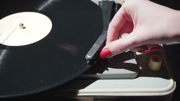 Vidéo de fille avec des ongles rouges allumant le gramophone rétro — Video