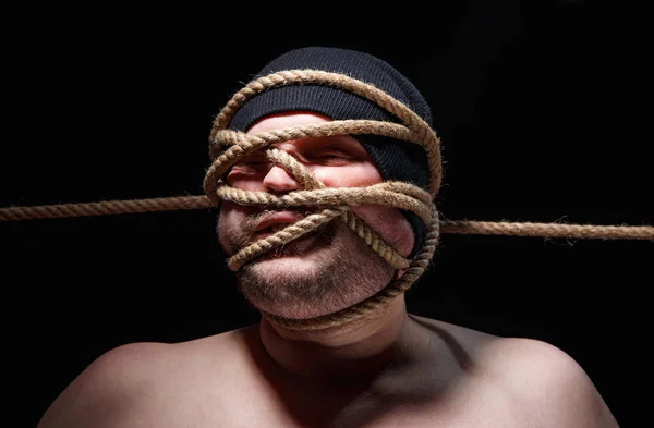 Portrait of binded fat man with rope on face — Stock Photo, Image