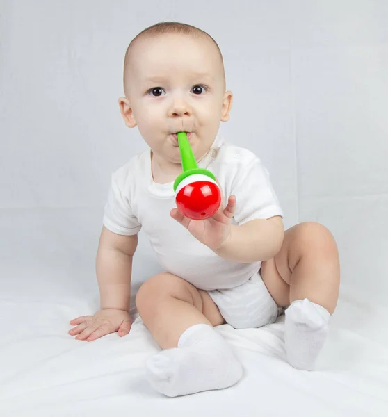 Image of a eight month old baby with bright rattle — Stock Photo, Image