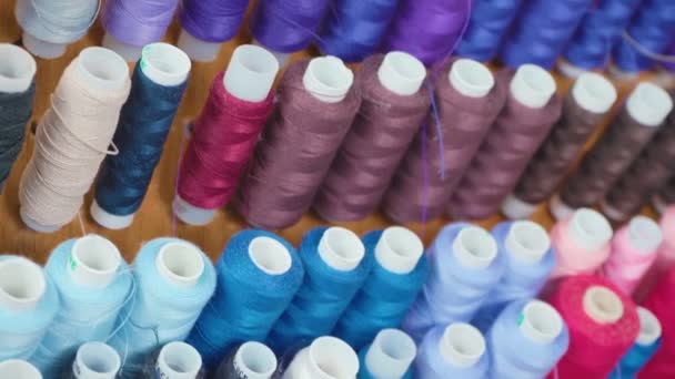 Footage of colourful spools of threads in workshop — Stock Video