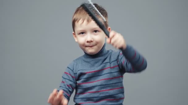 Shooting of little four-year boy with hairbrush — Stock Video