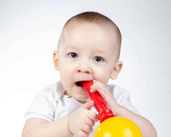 Foto de un bebé de once meses con sonajero en la boca — Foto de Stock