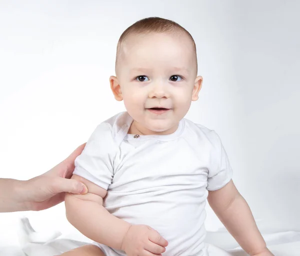 Image of sitting eleven-month-old baby on a white background — Stock Photo, Image