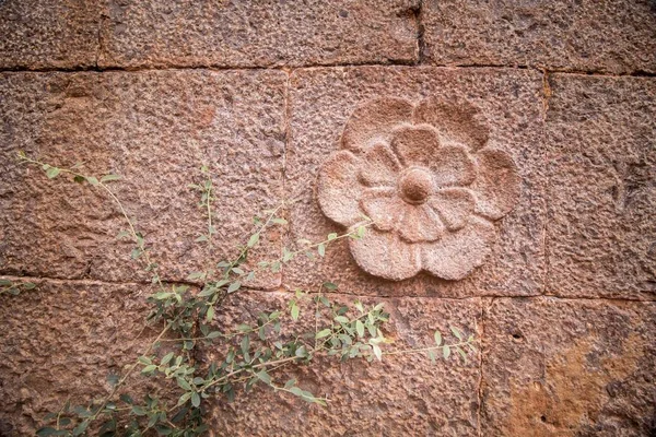 Flower carved into stone wall  of a historical monument for decoration