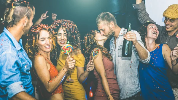 Happy friends having multiracial fun at new year 's eve celebration - Young people drinking and dancing at after party in night club - Friendship concept on drunk mood - Focus on yellow cloth woman — стоковое фото